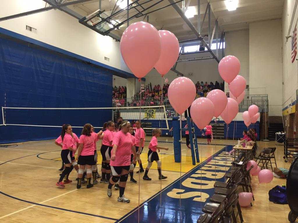 Girls Volleyball players wearing pink t-shirts